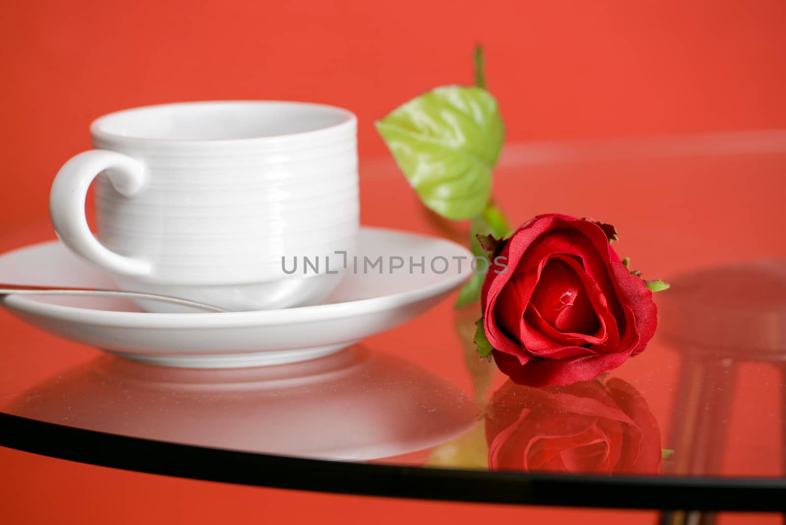 Cup of coffee on table on light background by Yuri2012