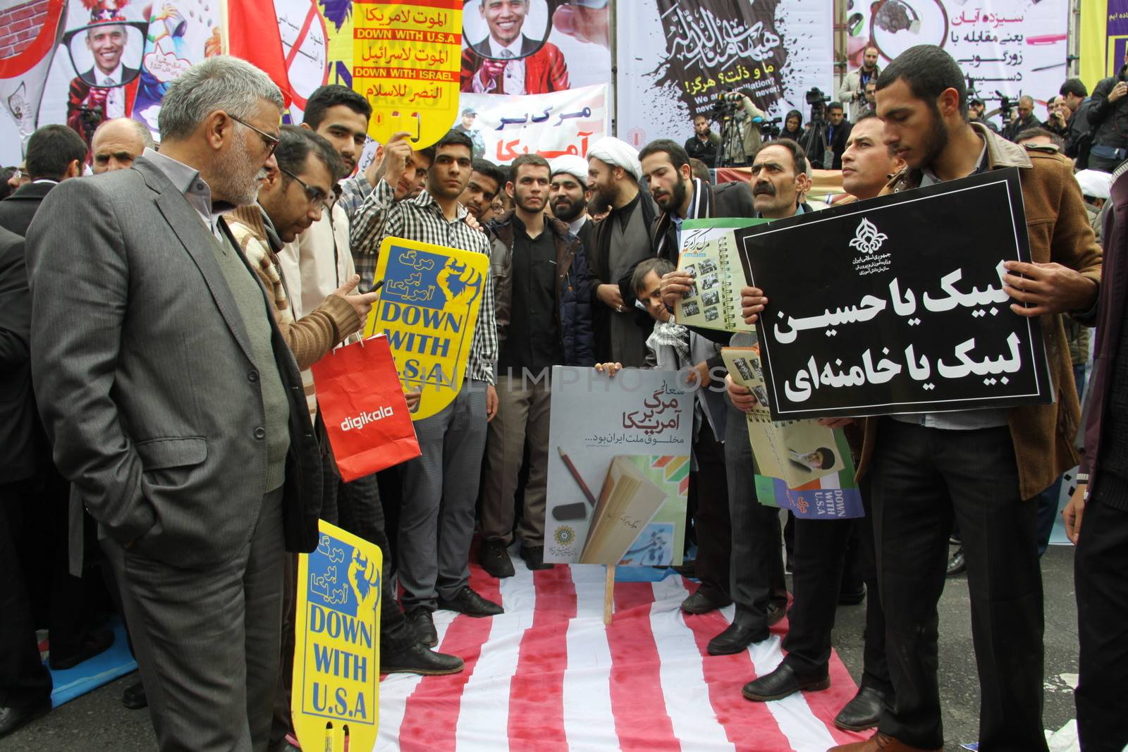 IRAN, Tehran: Protesters step on a flag of the US as hundreds of people march in front of the former US embassy in Tehran, during the '13 Aban' (4th of November in english), on November 4, 2015, to commemorate the anniversary of the 1979 US embassy taking.