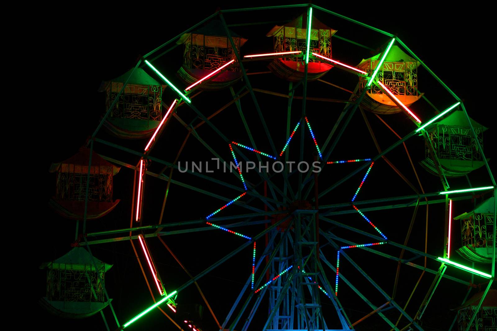 Colorful ferris wheel at night amusement park