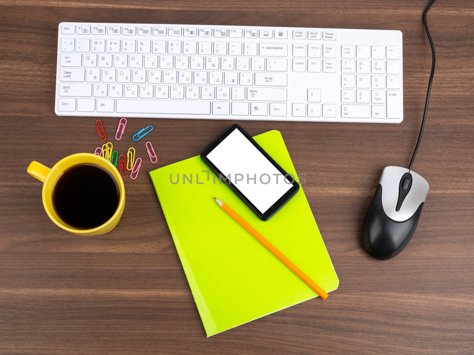 Keyboard with coffee and smartphone on table by cherezoff