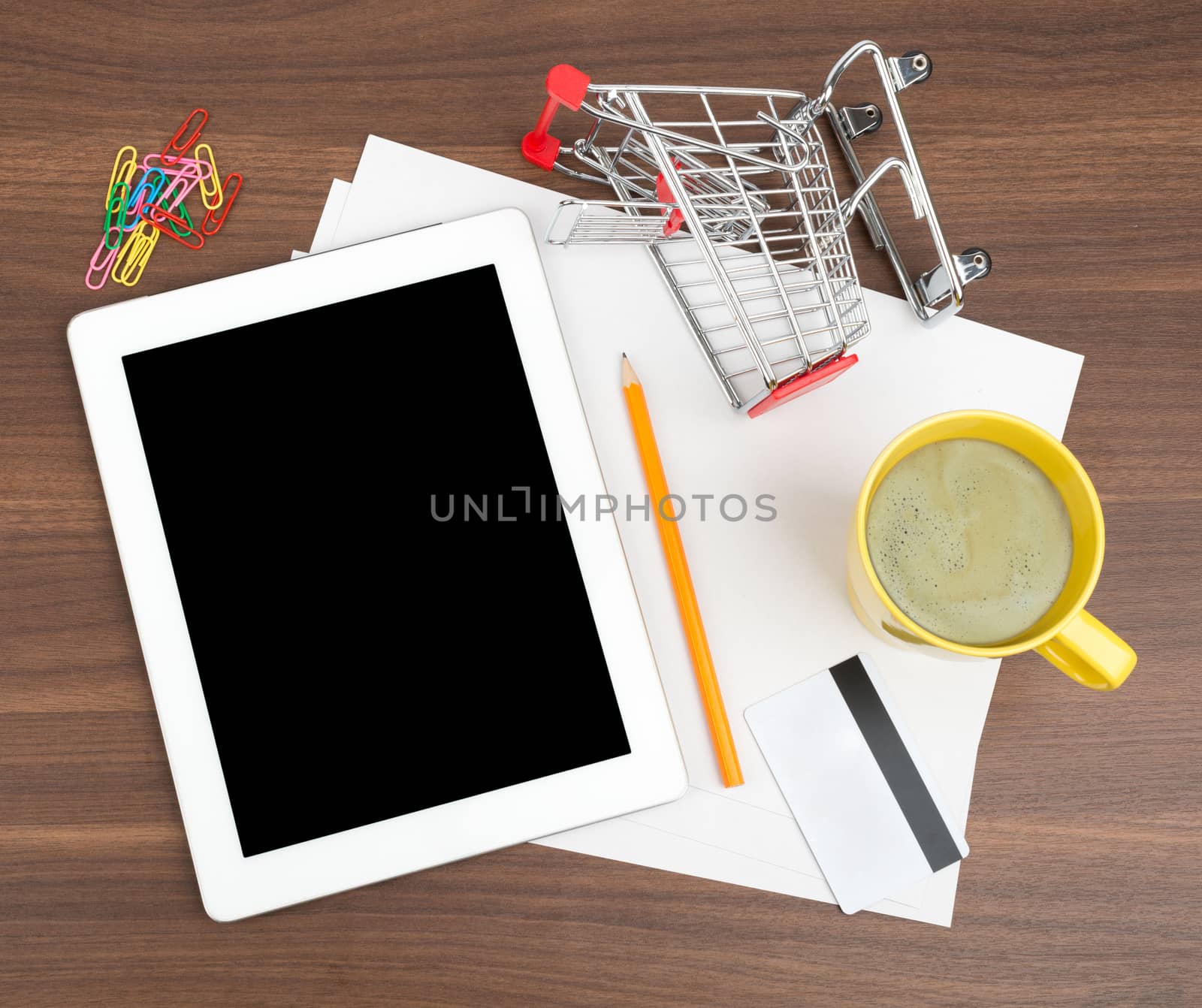 Tablet with blank paper and credit card by cherezoff