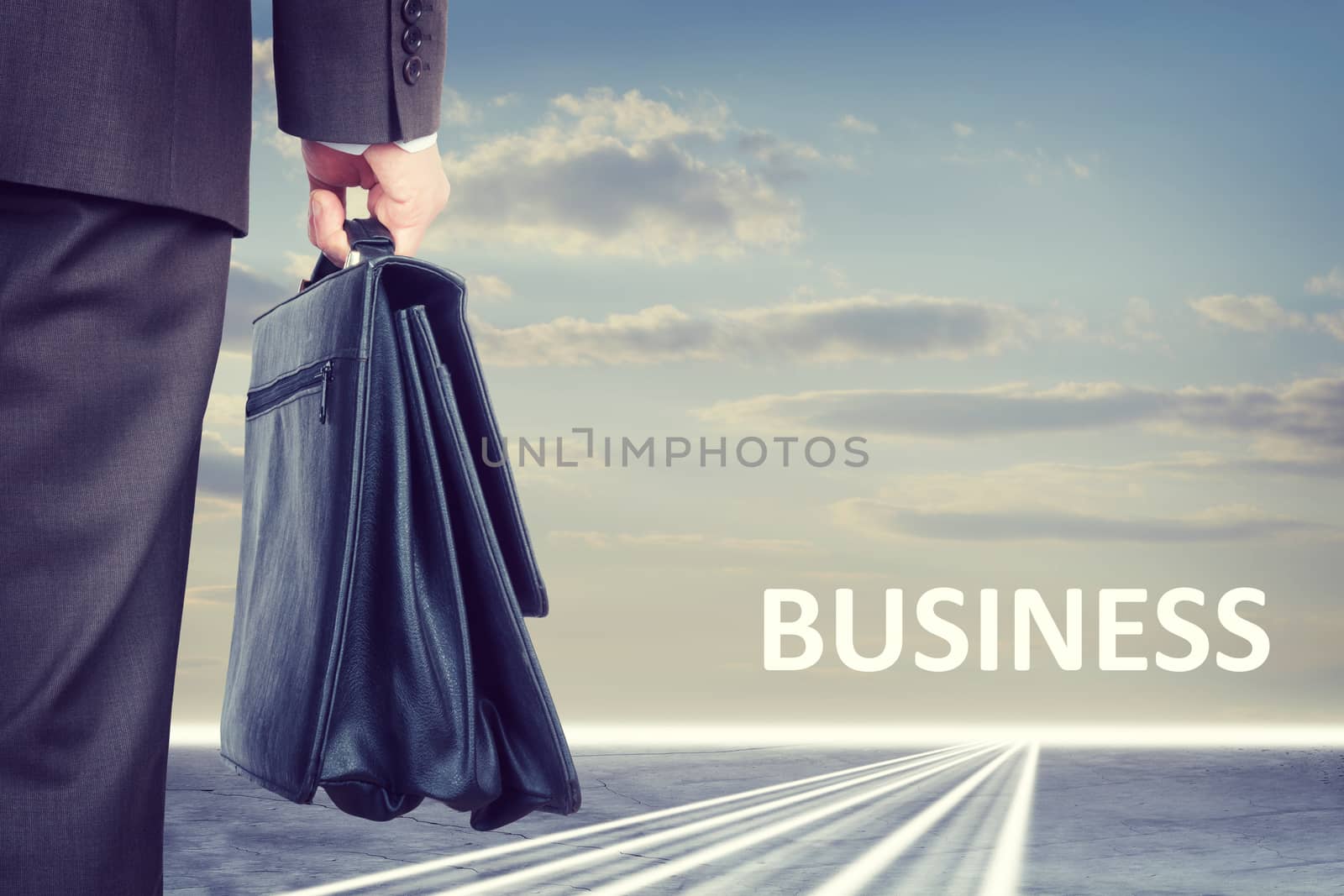 Businessman with suitcase and word business by cherezoff