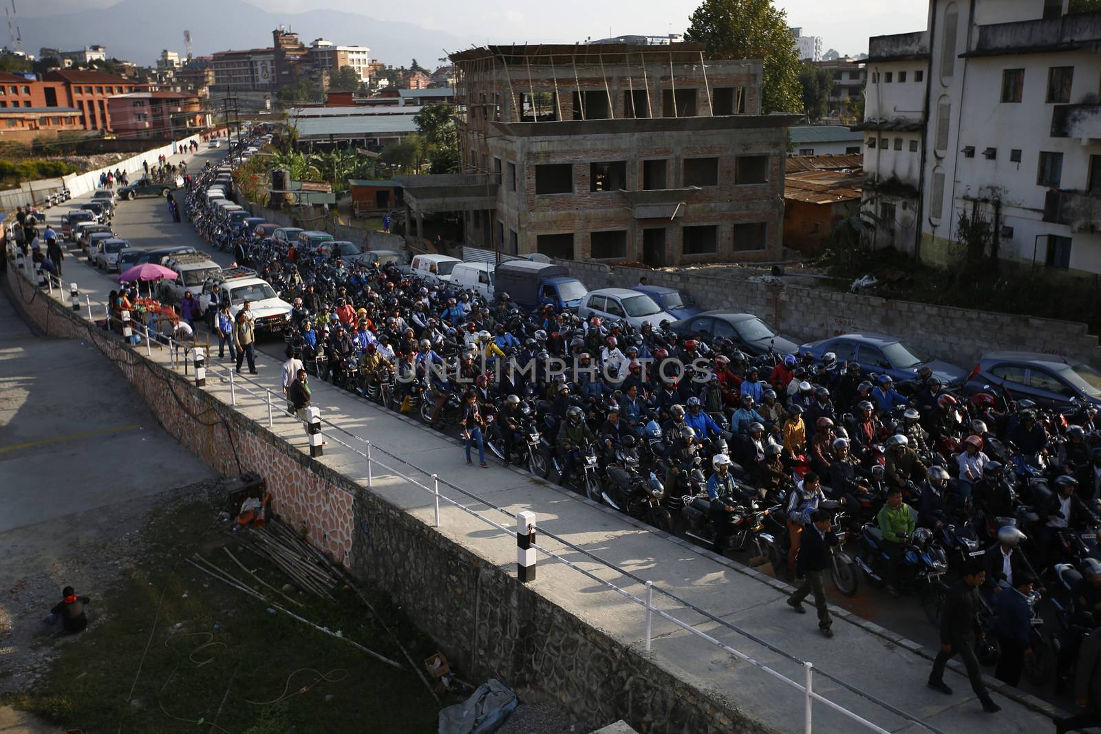 NEPAL, Kathmandu: Motorists wait in a queue for petrol near a petrol station in Kathmandu on November 4, 2015. Nepal signed a deal last week with China to import petroleum products, its embassy in Beijing said, as the Himalayan nation tries to boost supplies to deal with a deepening fuel crisis. The curfew imposed in Birgunj, Nepal after violent protests where one person was killed near the Shankaracharya Gate close to the Nepal-India border on Monday causing tight security for goods to arrive.