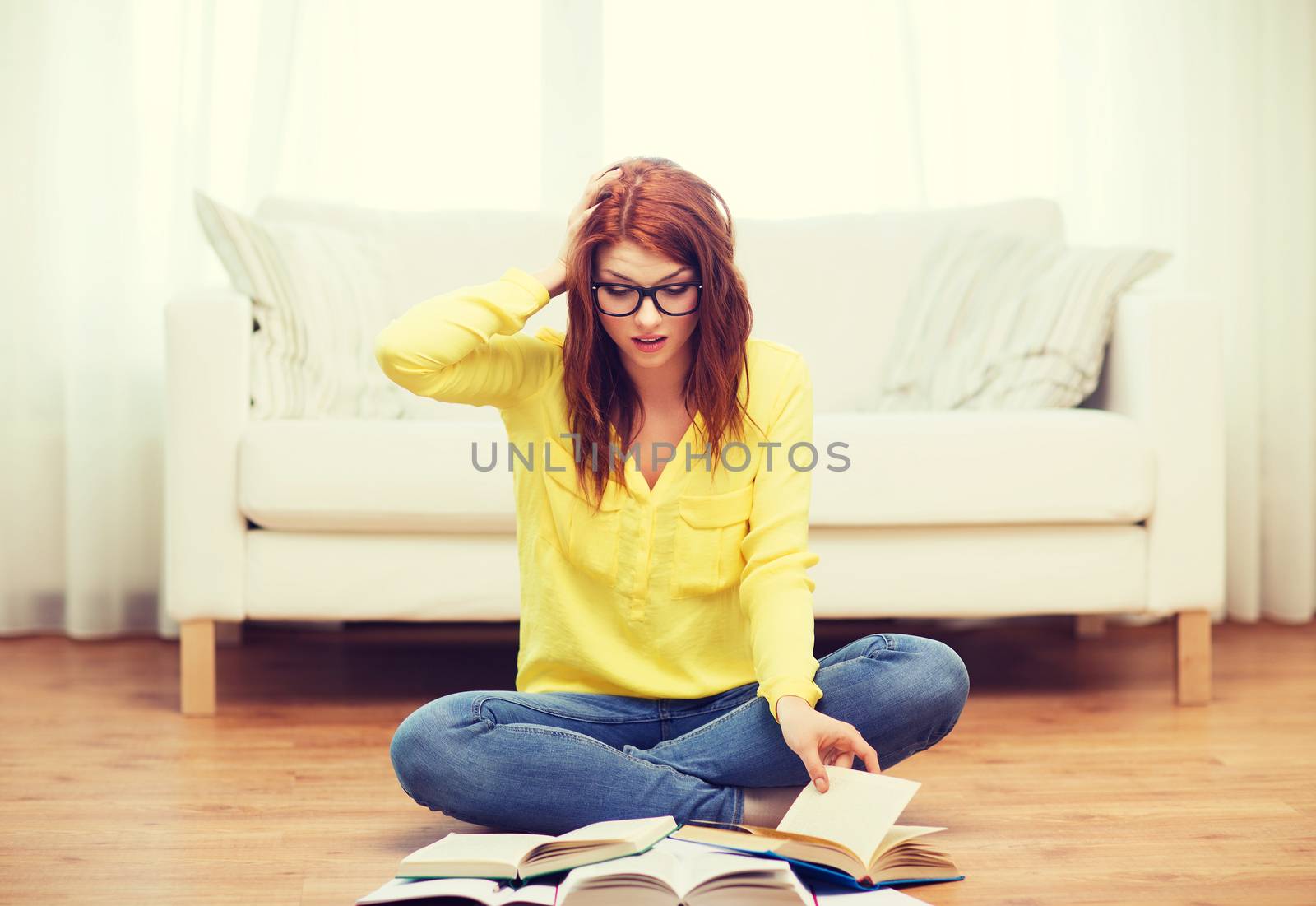 education concept - stressed student girl reading books at home