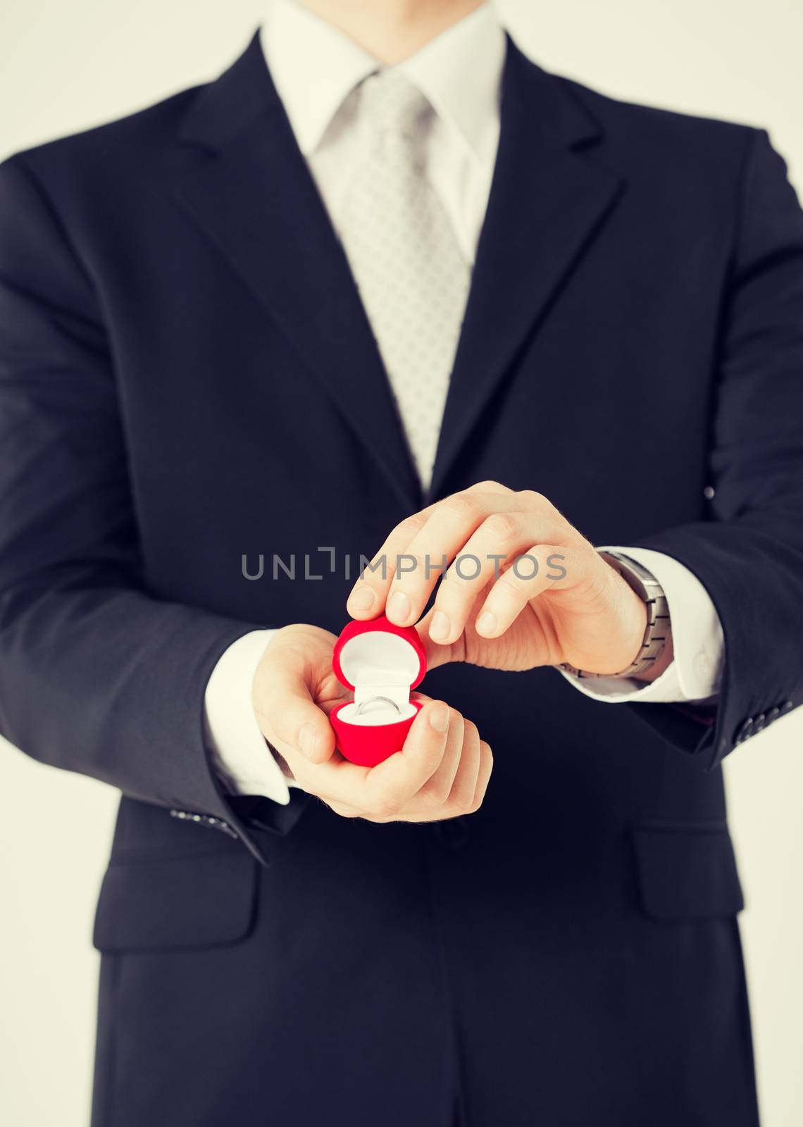man with gift box and wedding ring by dolgachov