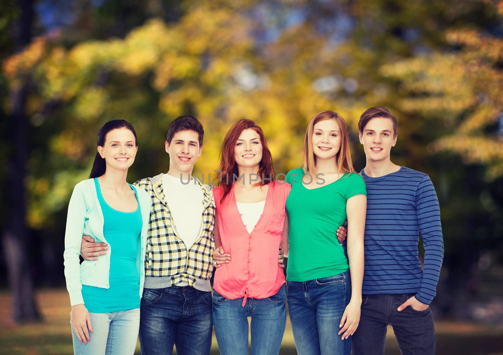 education and people concept - group of smiling students standing