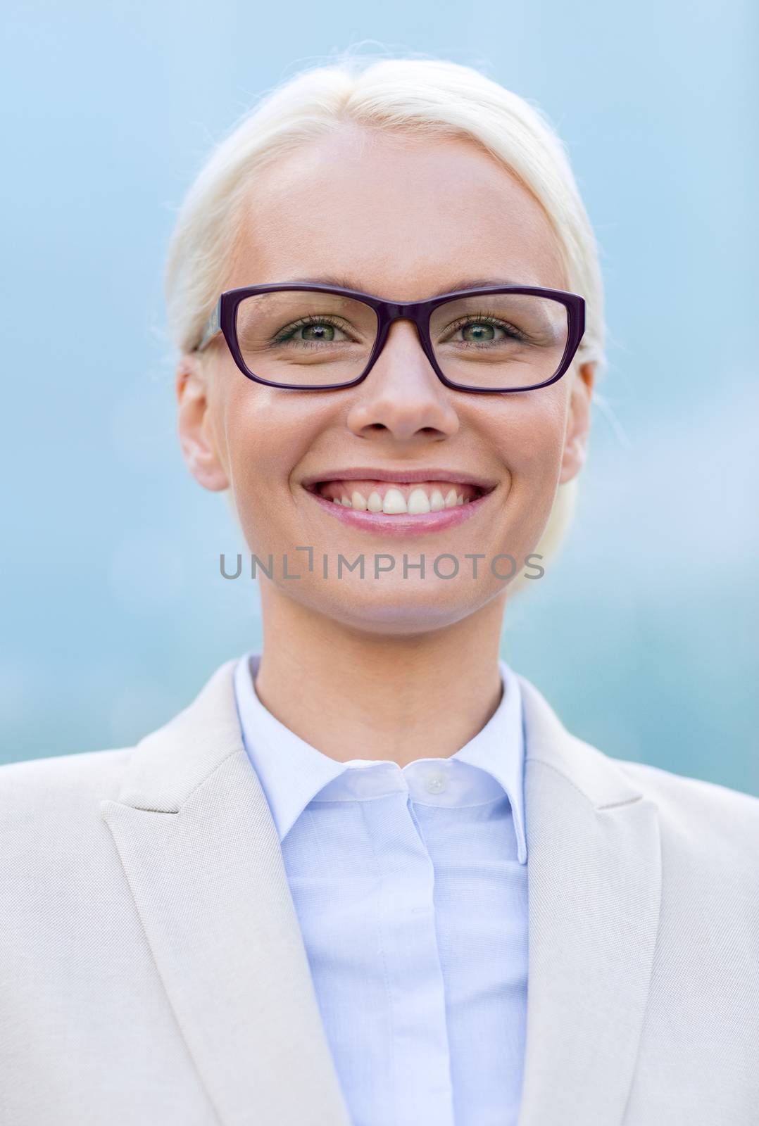 young smiling businesswoman over office building by dolgachov