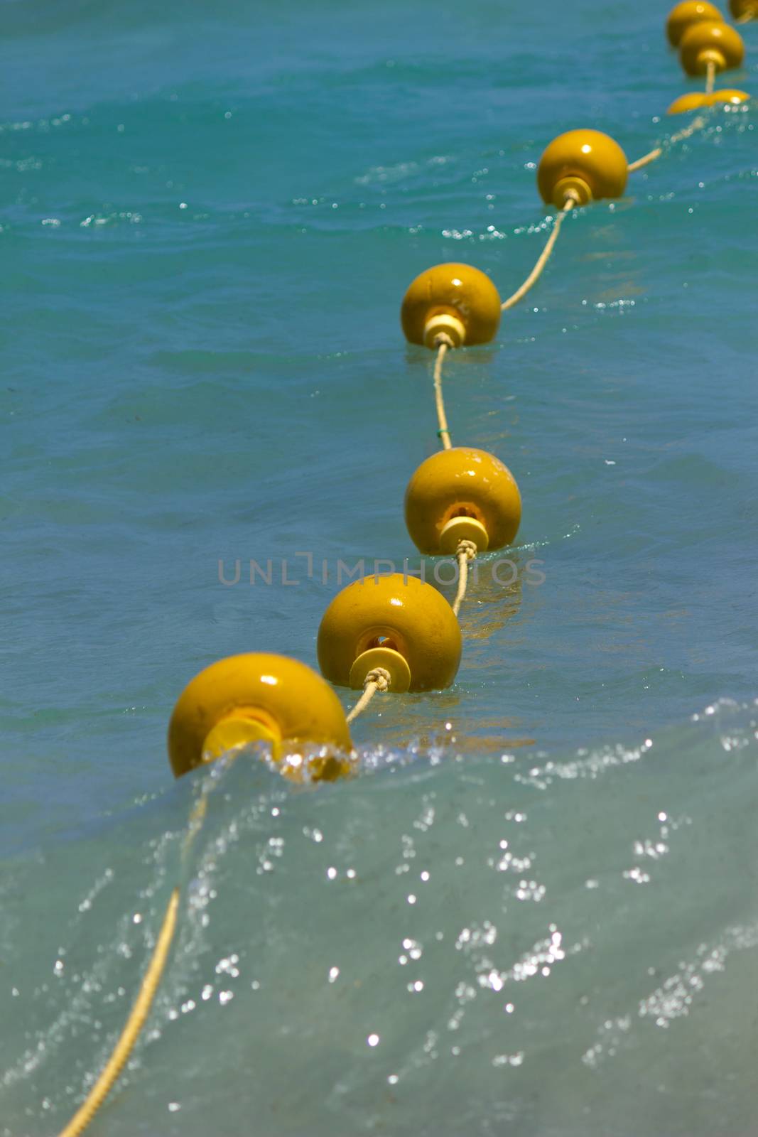 Yellow buoys in the sea by Kidza