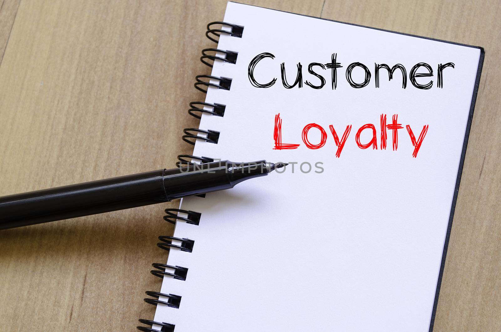 Customer loyalty write on notebook by eenevski
