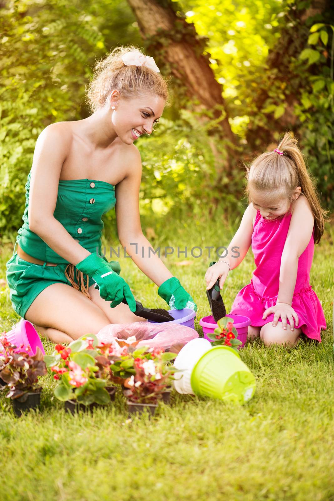 Beautiful Mother And Daughter Planting Flowers by MilanMarkovic78