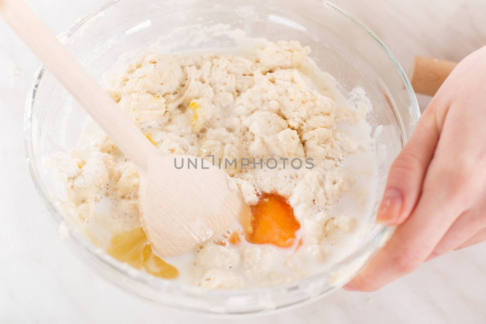 Making dough with mixing spoon. Close-up.