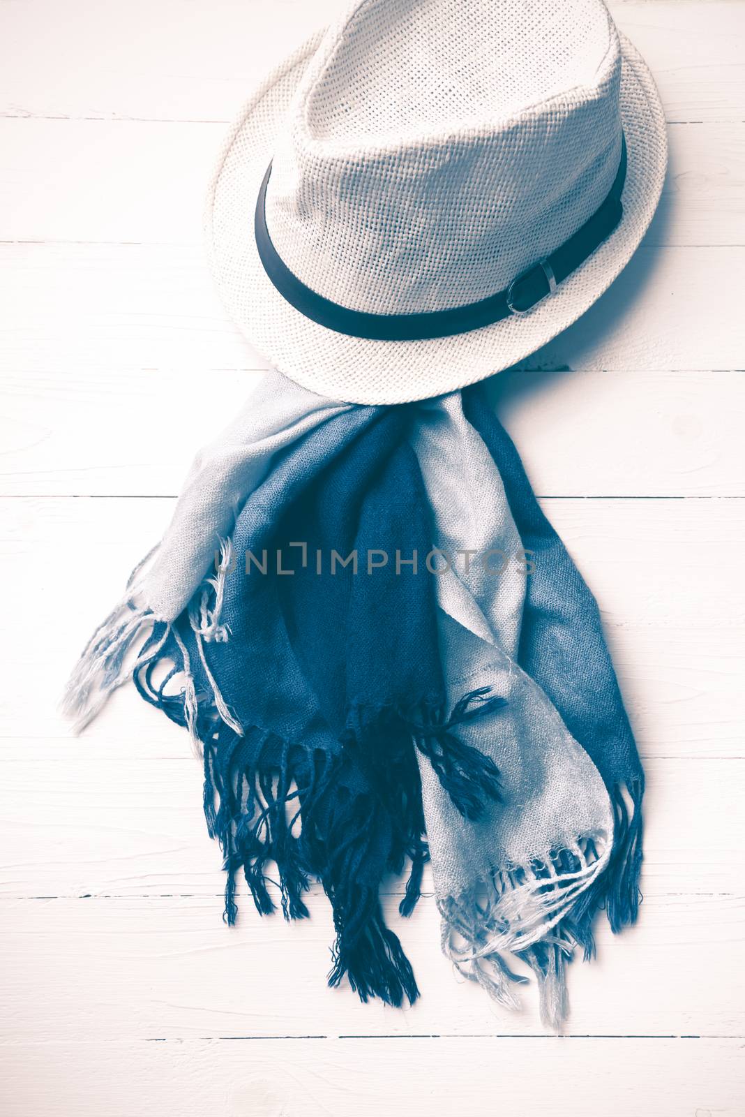 hat and blue scarf on white table vintage style