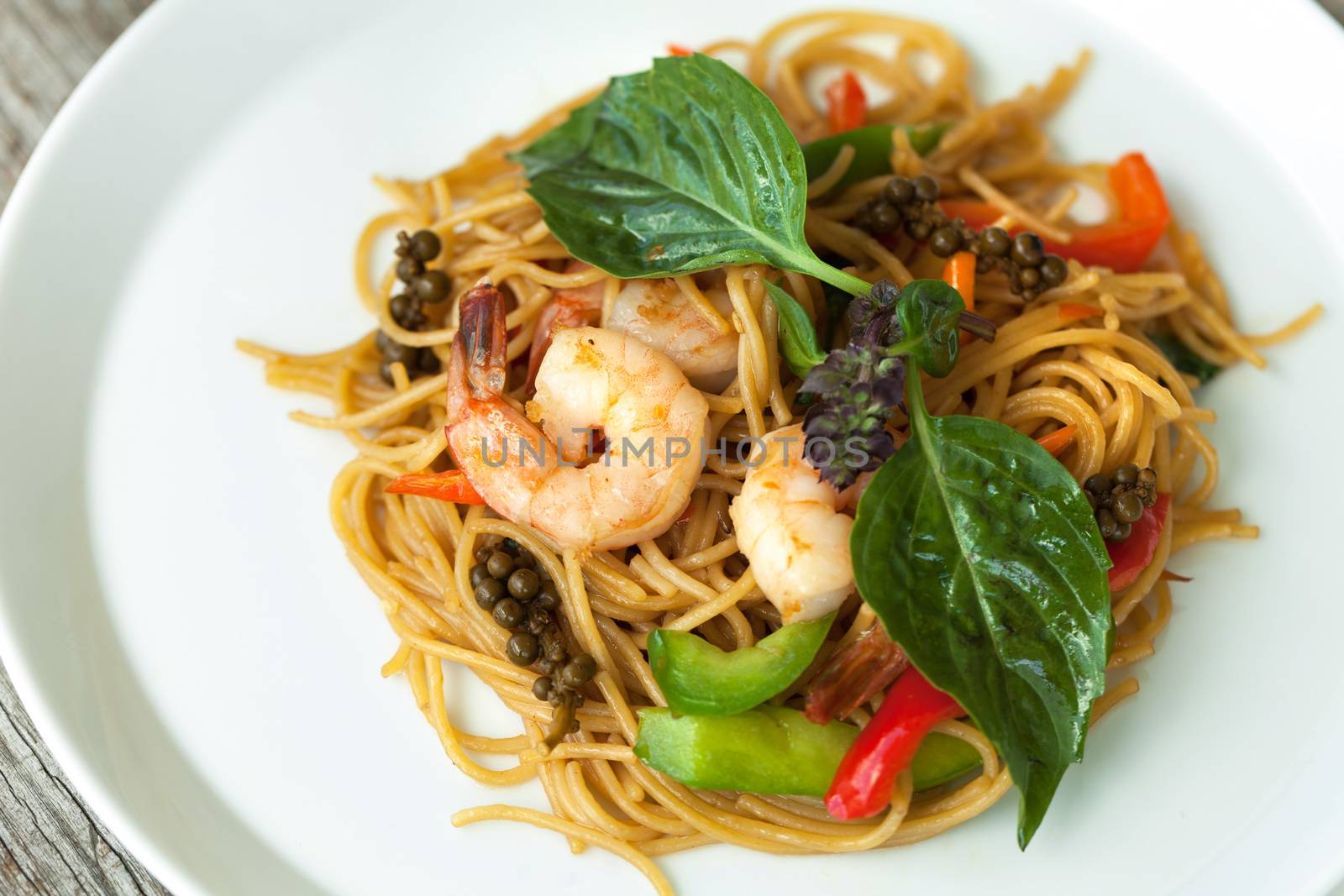 Thai food dishes with shrimp and noodles and soup with duck.  Shallow depth of field. 