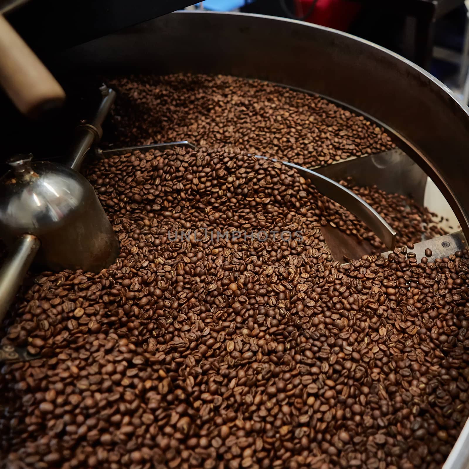 Freshly roasted coffee beans in a coffee roaster. Shallow dof