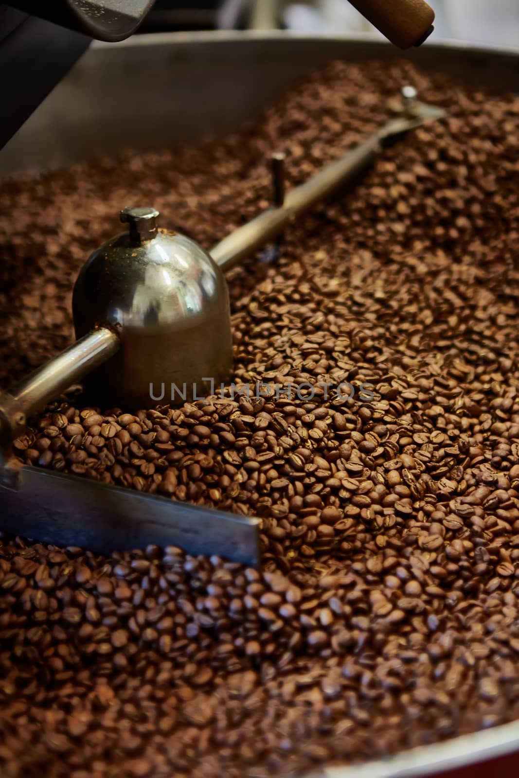 Freshly roasted coffee beans in a coffee roaster. Shallow dof