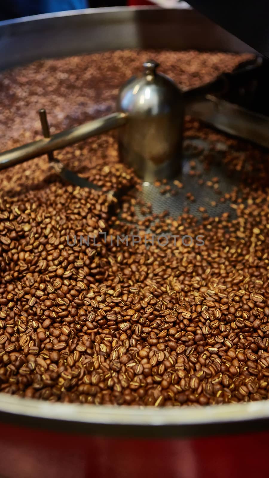 Freshly roasted coffee beans in a coffee roaster. Shallow dof