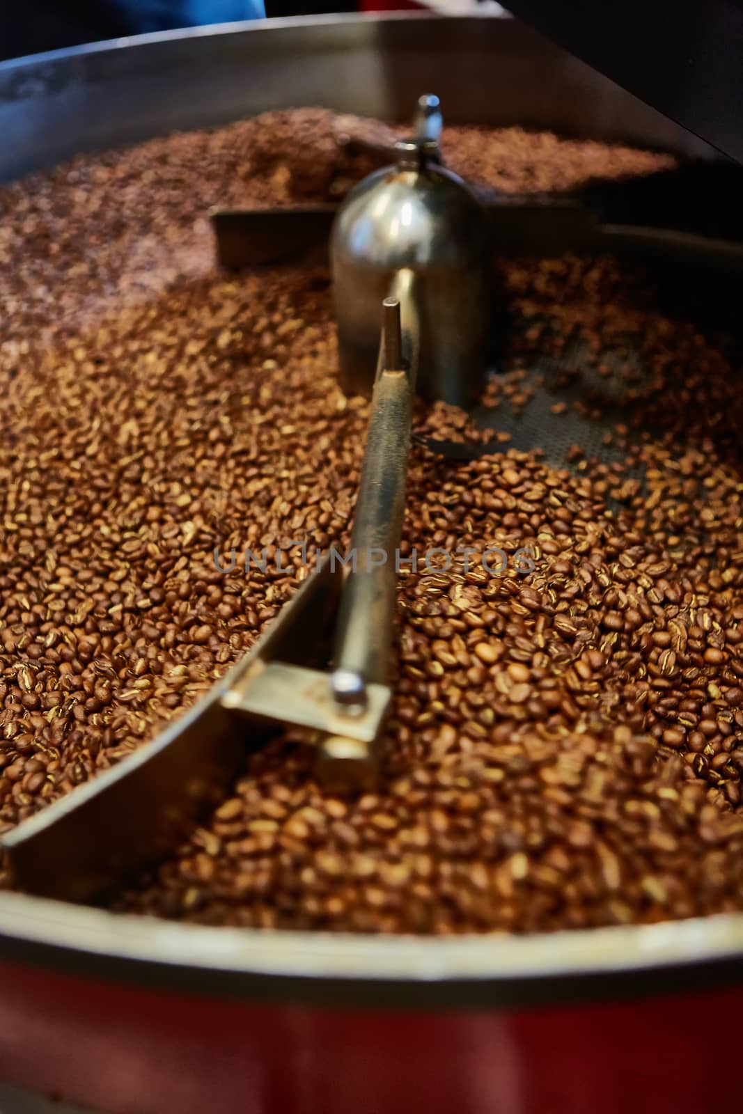 Freshly roasted coffee beans in a coffee roaster. Shallow dof