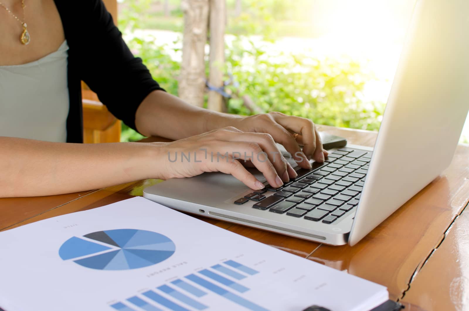 Close up of a woman hands typing in a laptop.