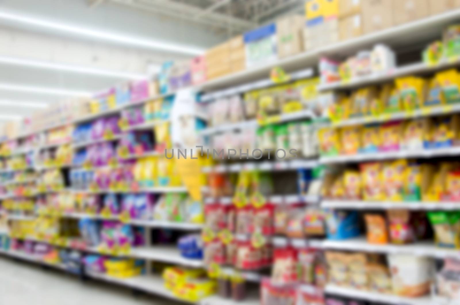 blurred image of supermarket people shopping - product shelf