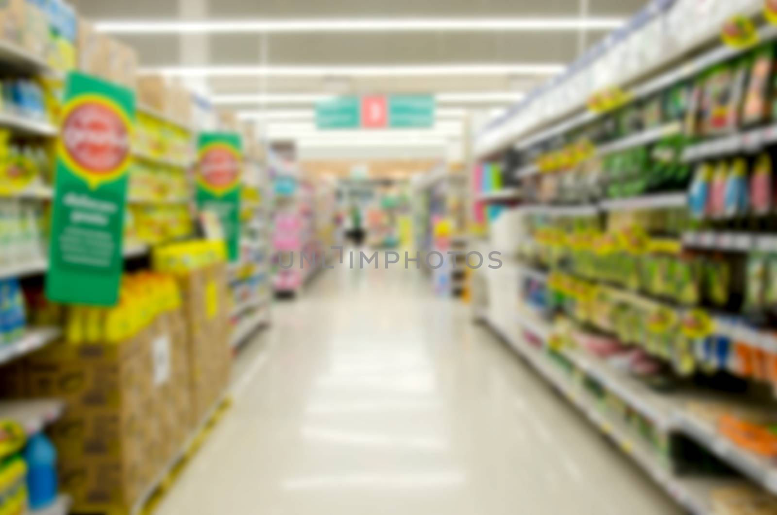 blurred image of supermarket people shopping - product shelf