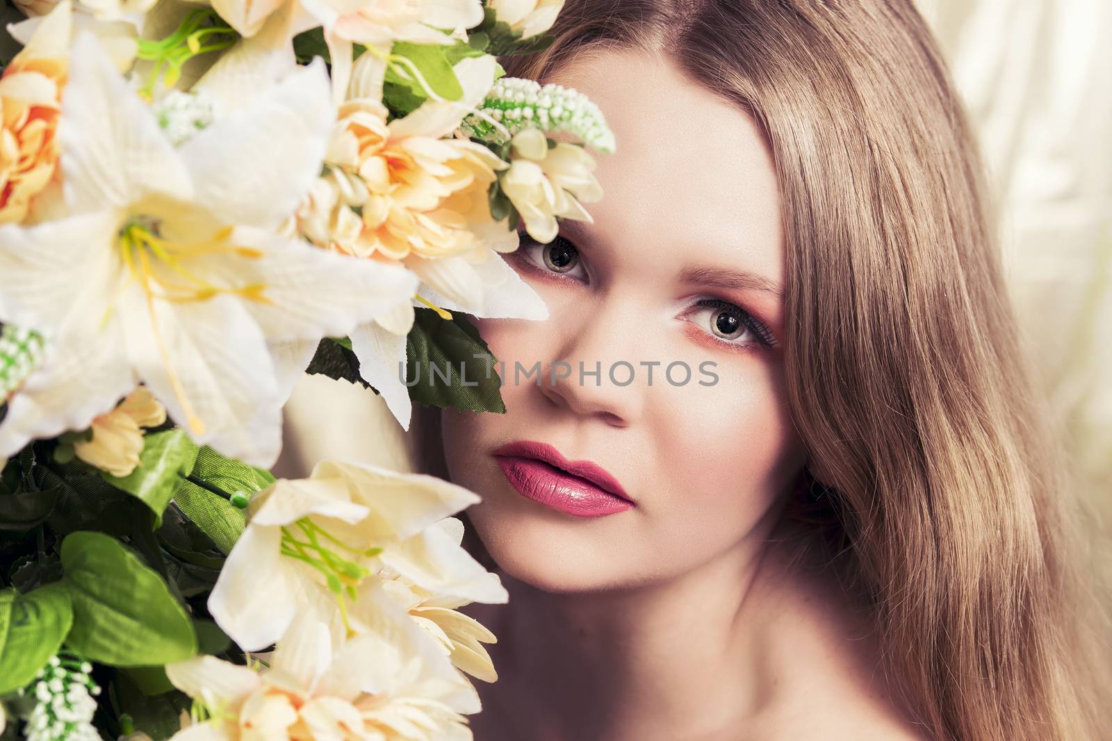 Cinematic portrait of a beautiful blonde woman with flowers all around her.