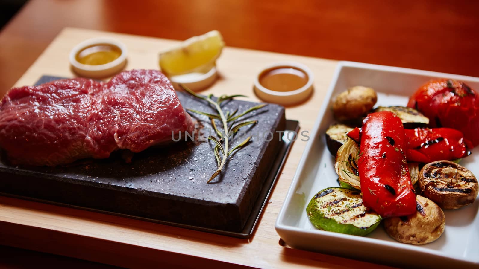 meat grilled on a stone with vegetables on the plate