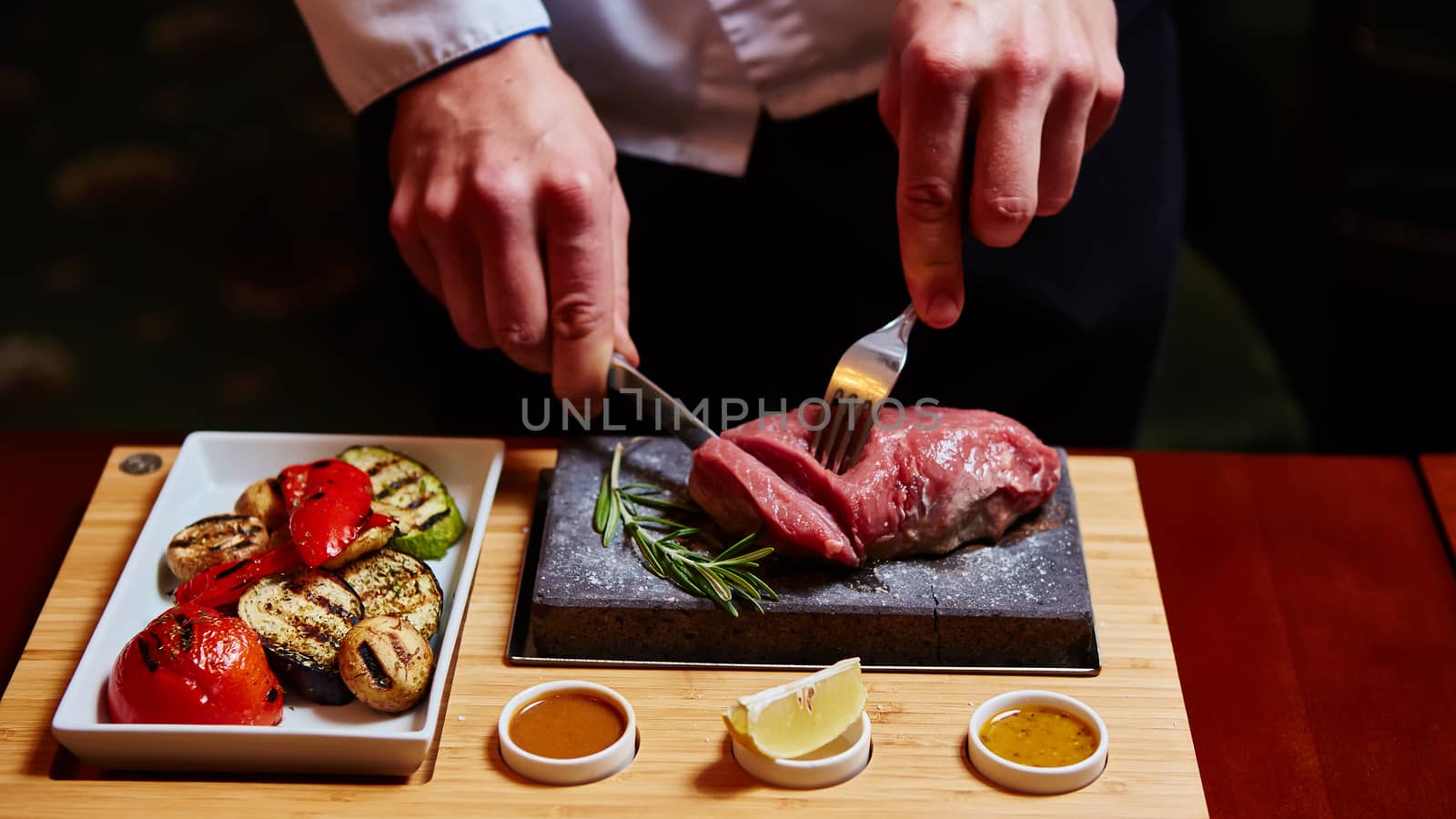 meat grilled on a stone with vegetables on the plate