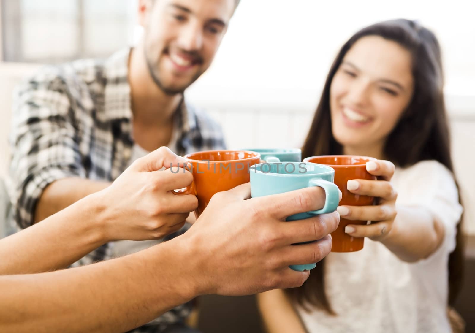 Group of friends making a toast with coffee