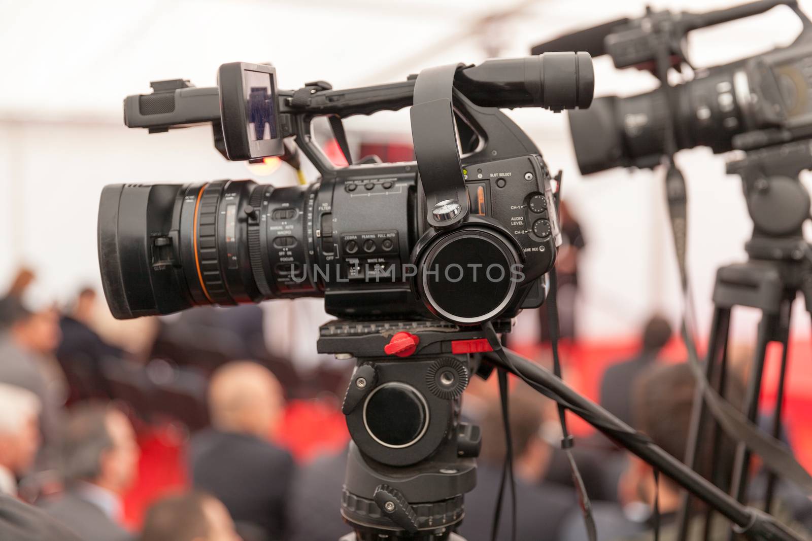 Filming an event with a video camera by wellphoto