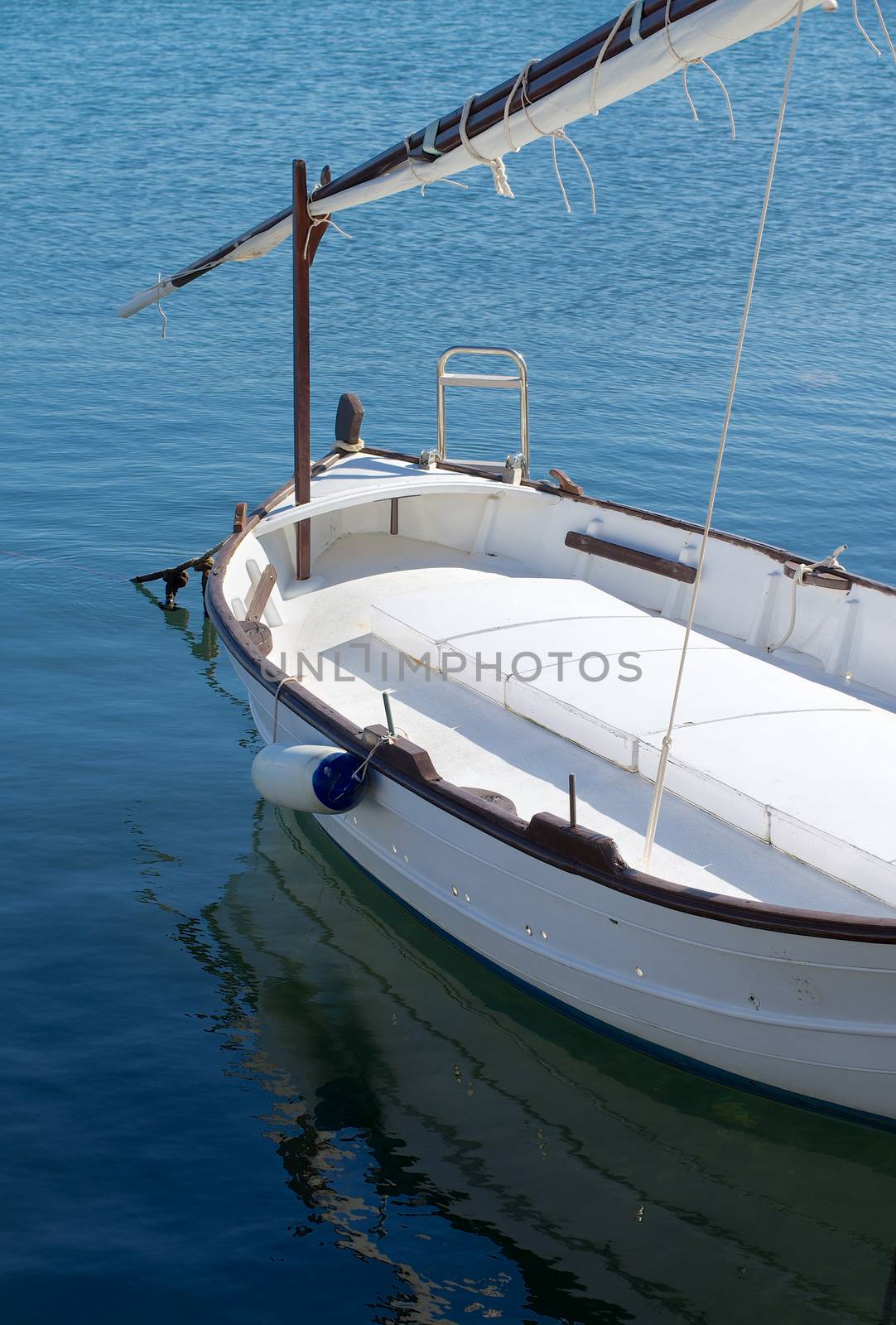 Old Sailing Boat with Folded Sail in Harbor Outdoors