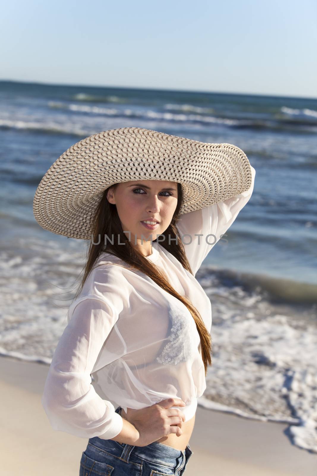 woman with a hat on a beach