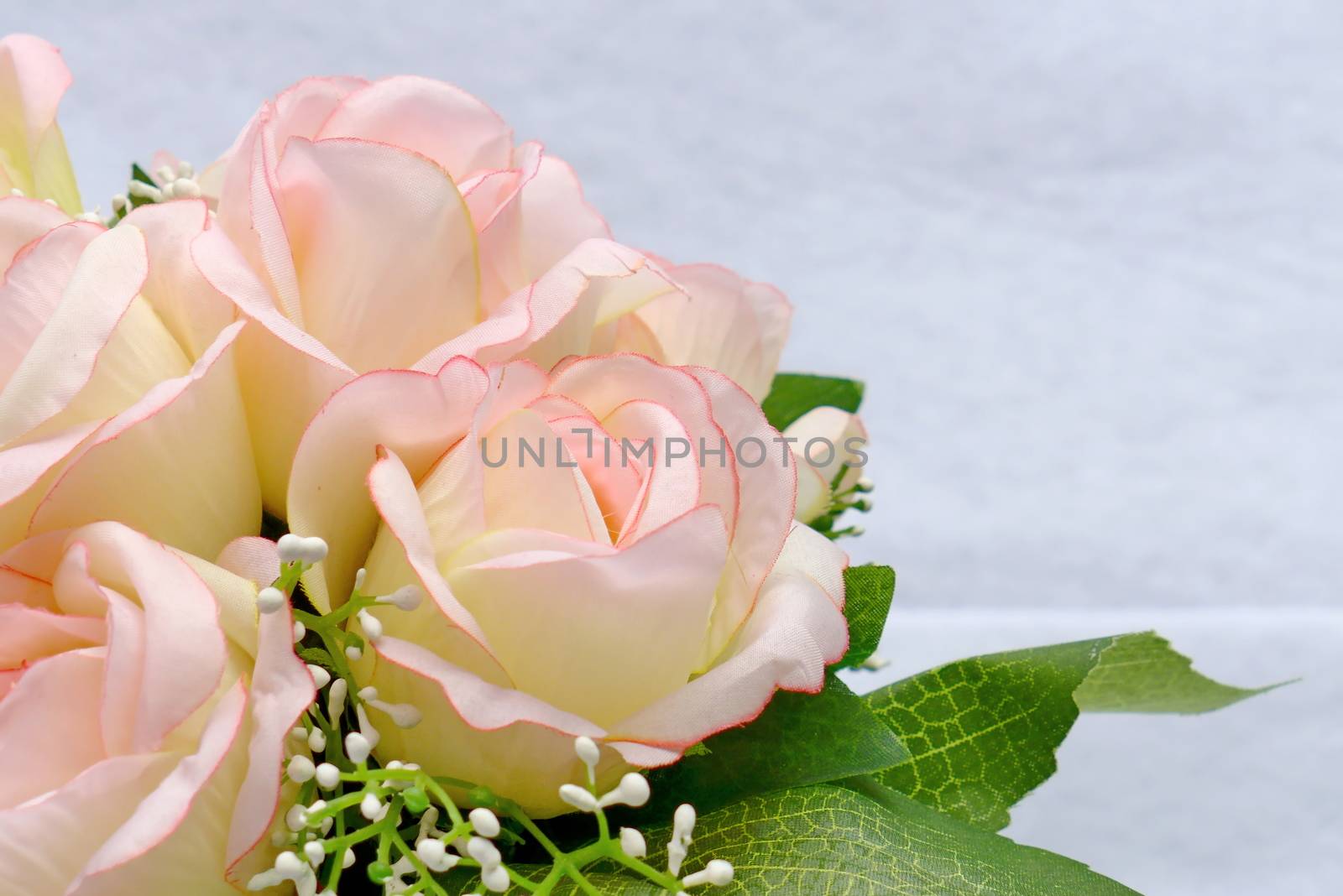 Pink artificia flower on white cloth background