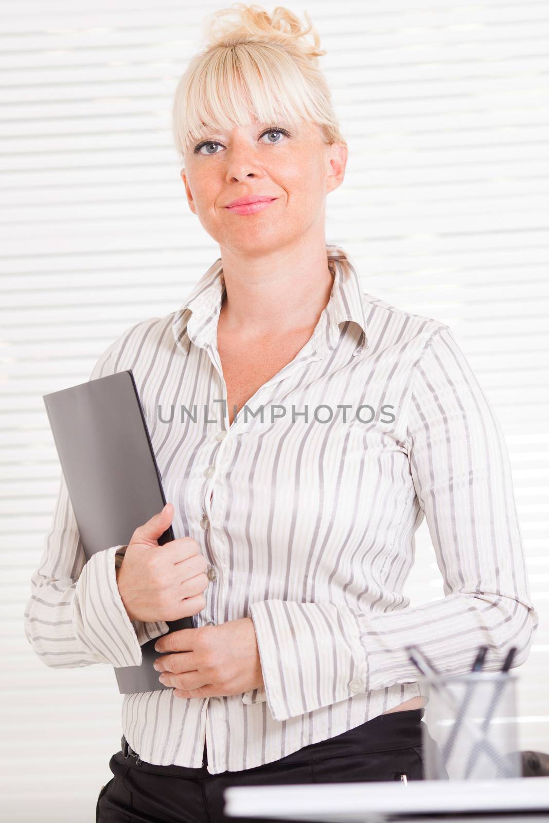 Beautiful mature Business woman standing in the office with document