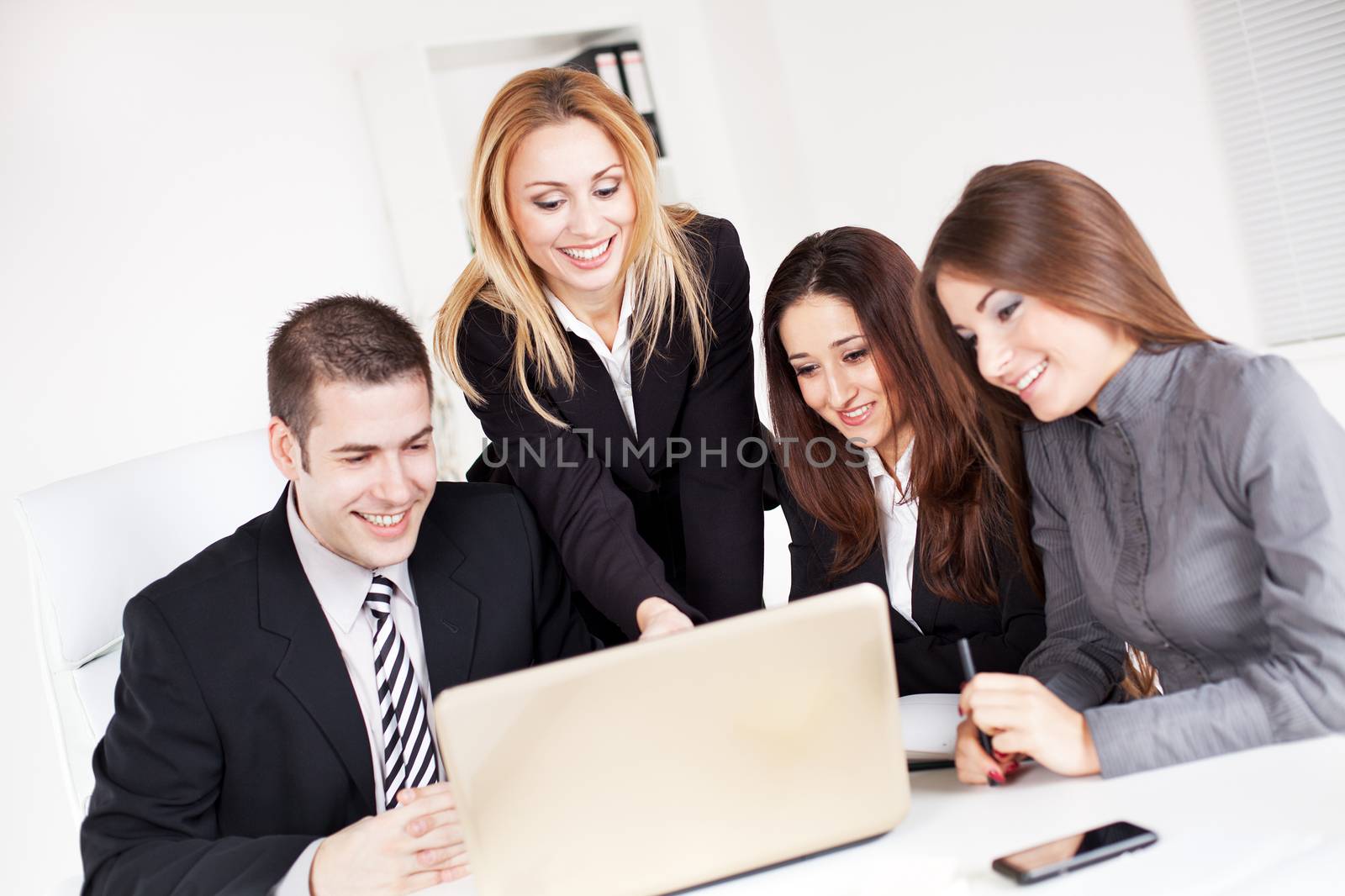 Happy Business woman showing her colleagues project at laptop in the office.