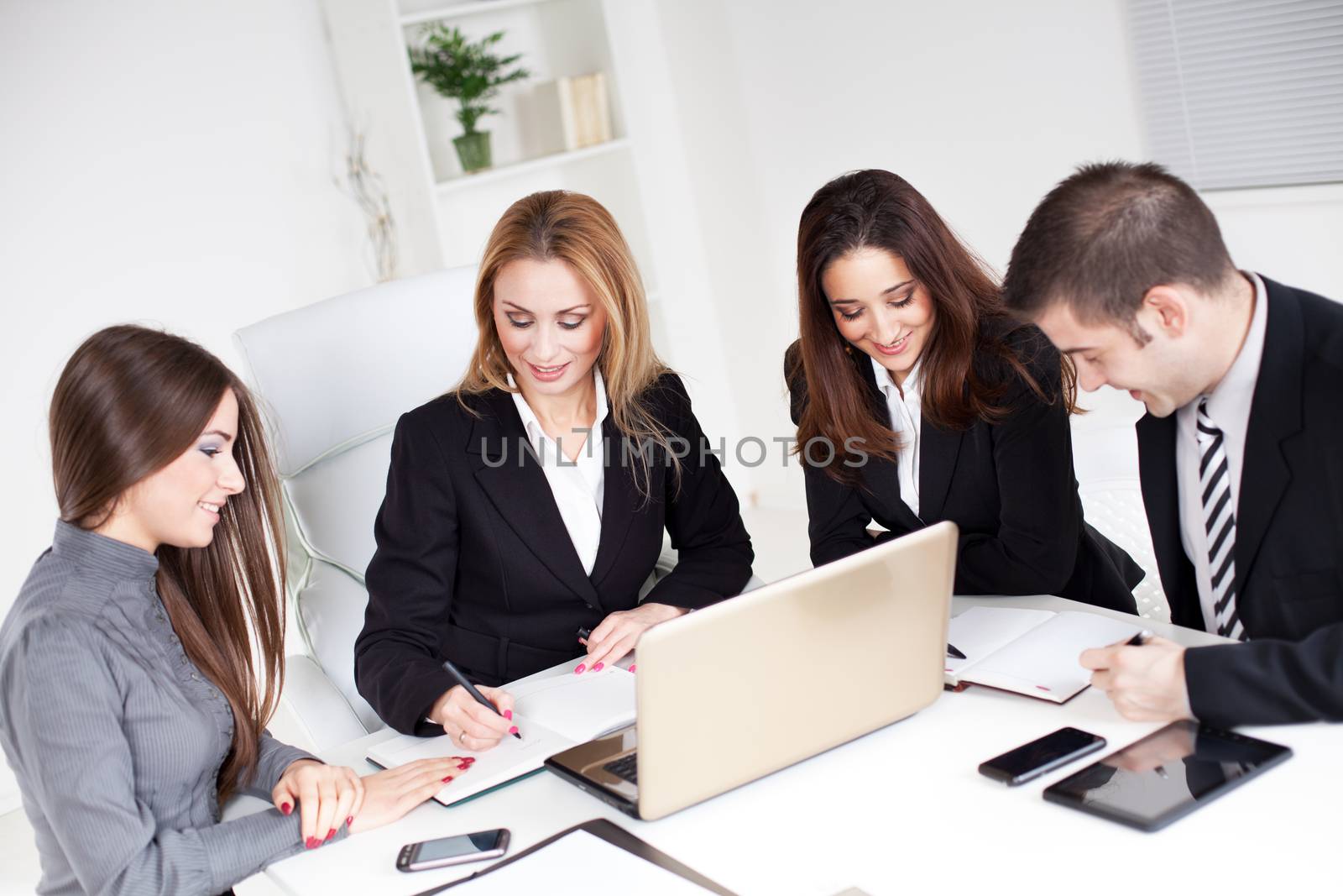 Four happy Business people talking in the office.