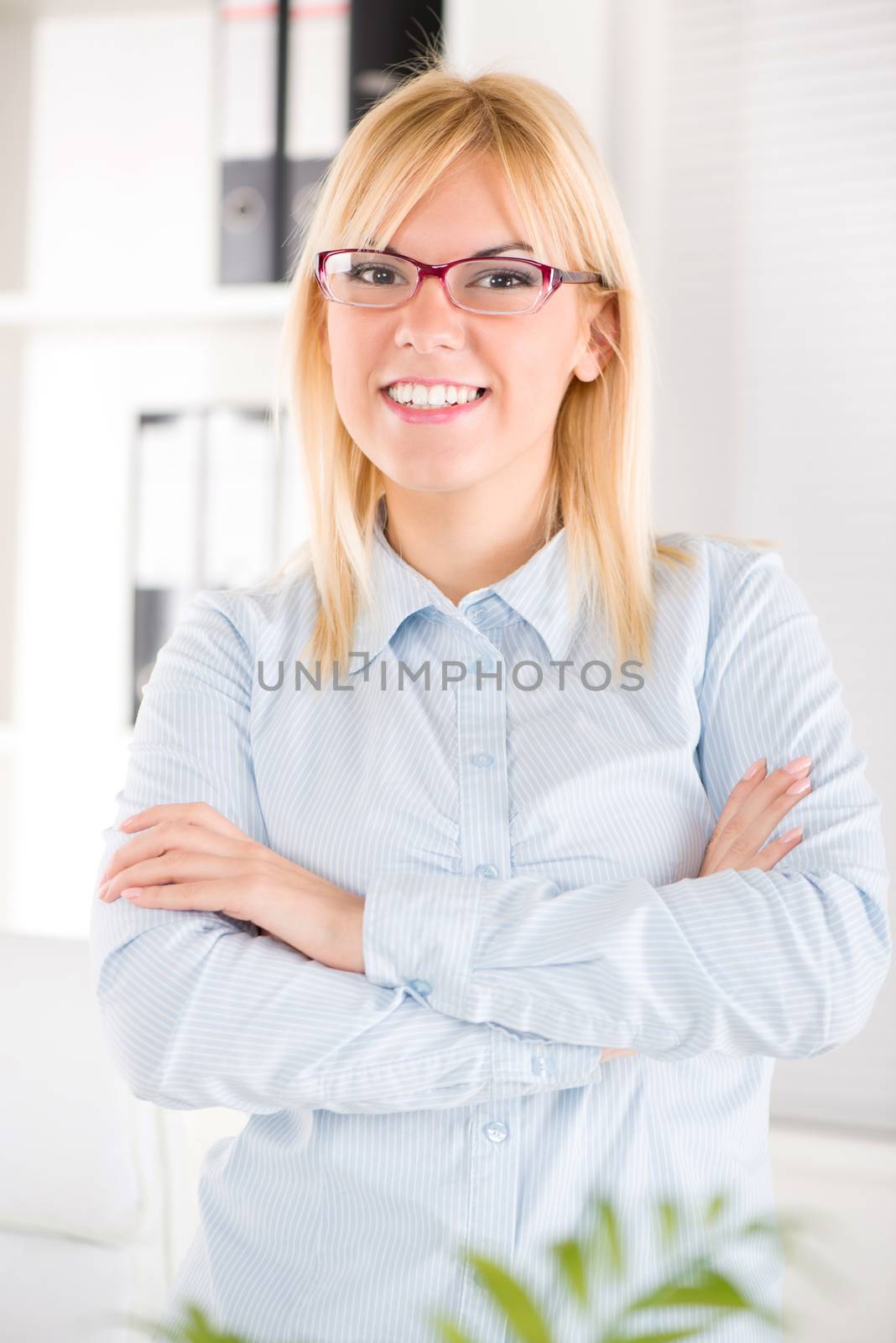 Beautiful Businesswoman with glasses standing in the office.
