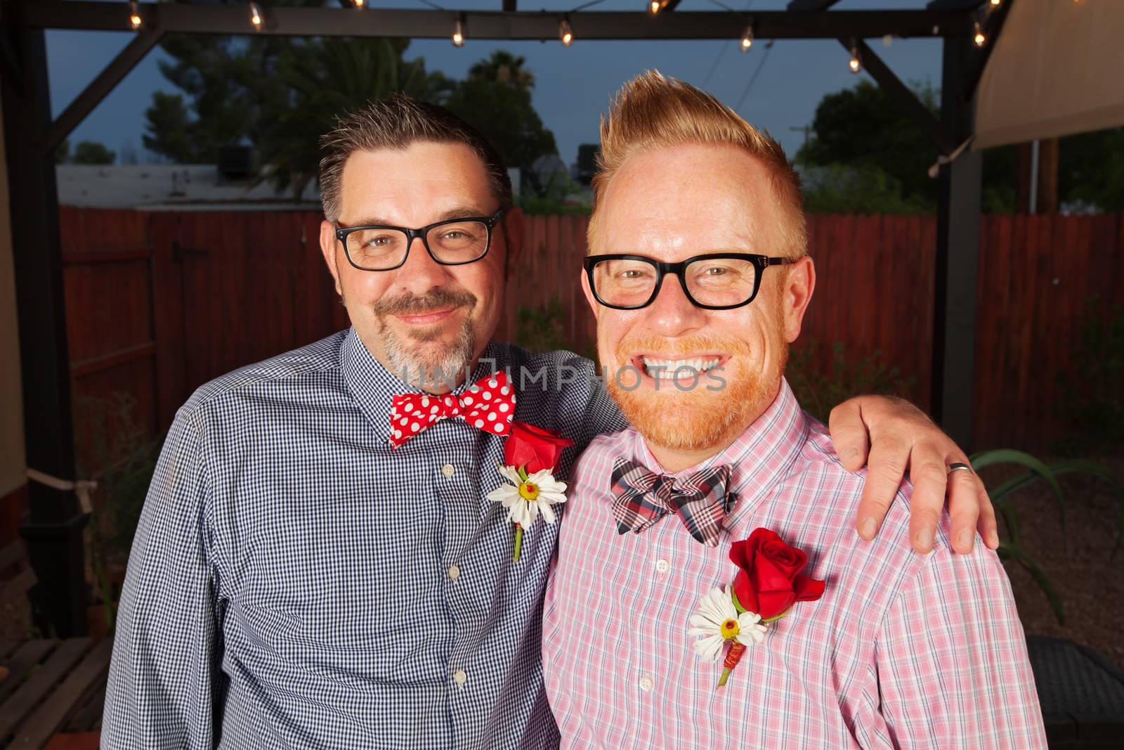 Pair of cute middle aged male newlyweds smiling
