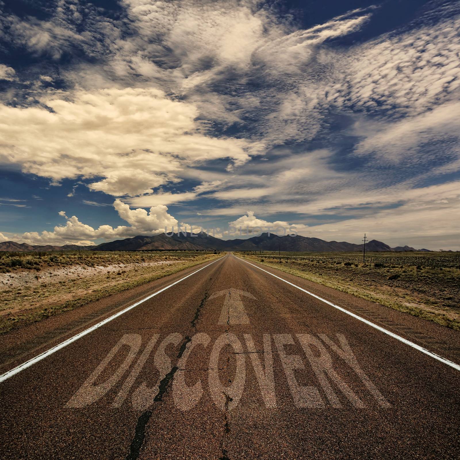 Conceptual image of desert road with the word discovery and arrow