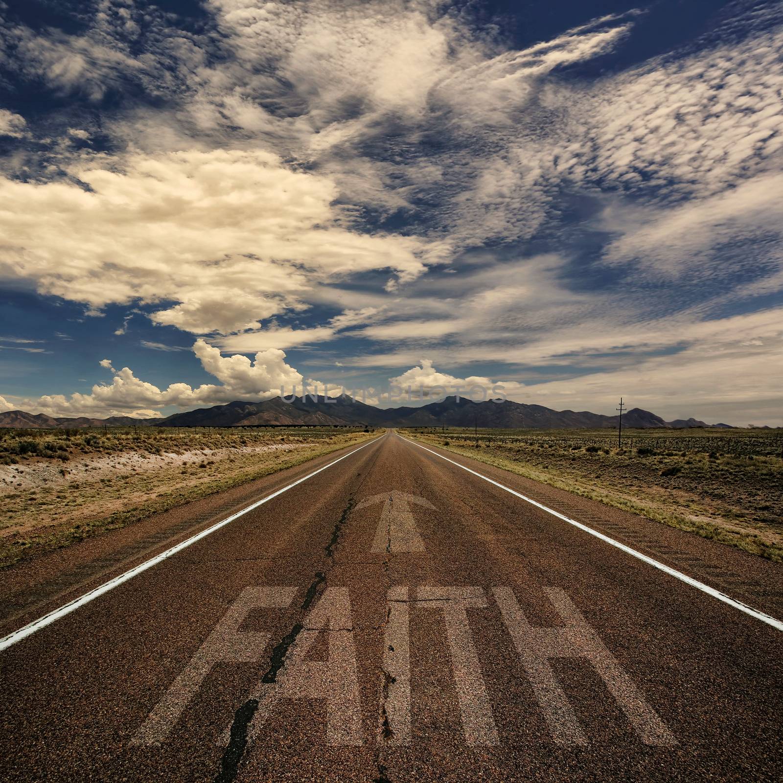 Conceptual image of desert road with the word faith and arrow