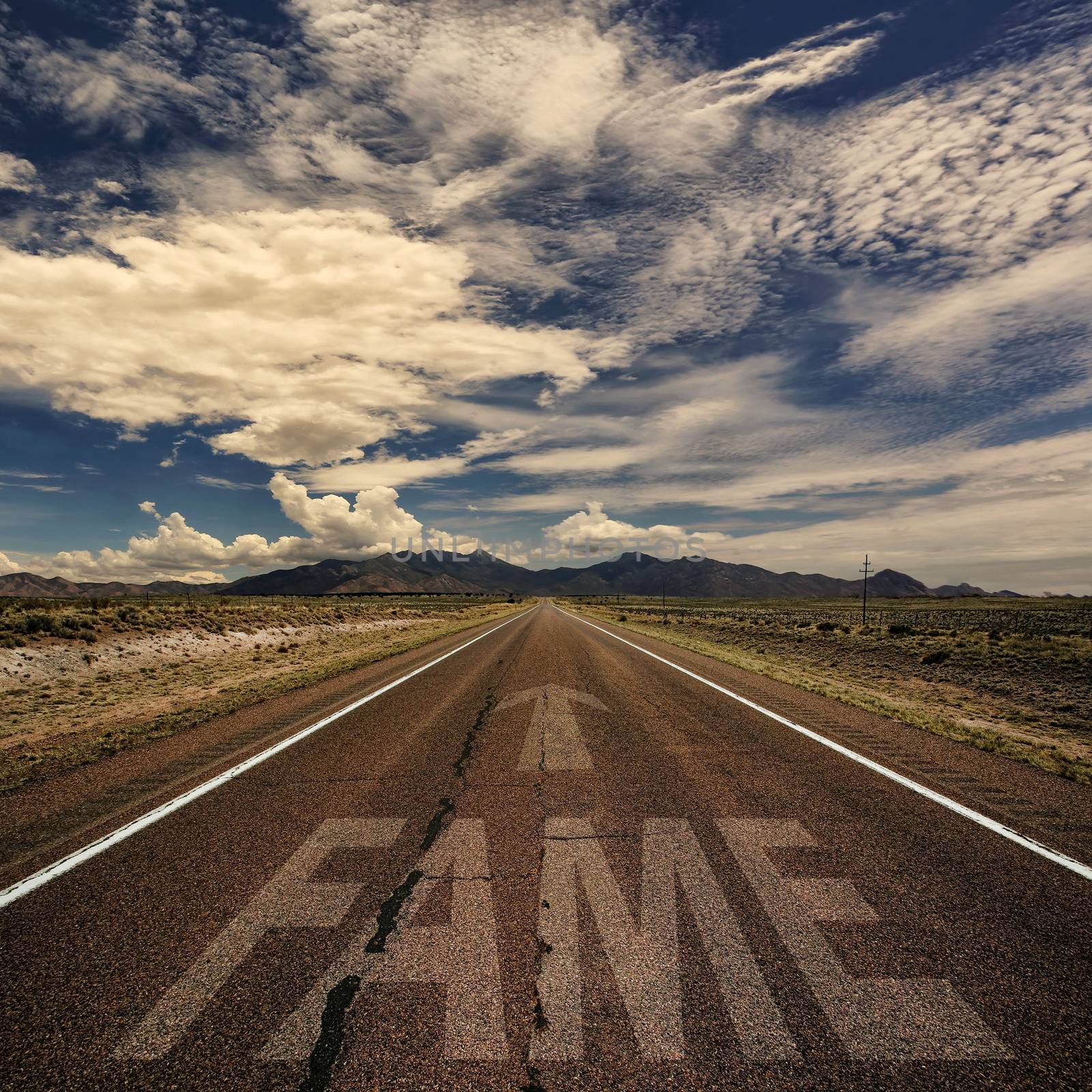 Conceptual image of desert road with the word fame and arrow
