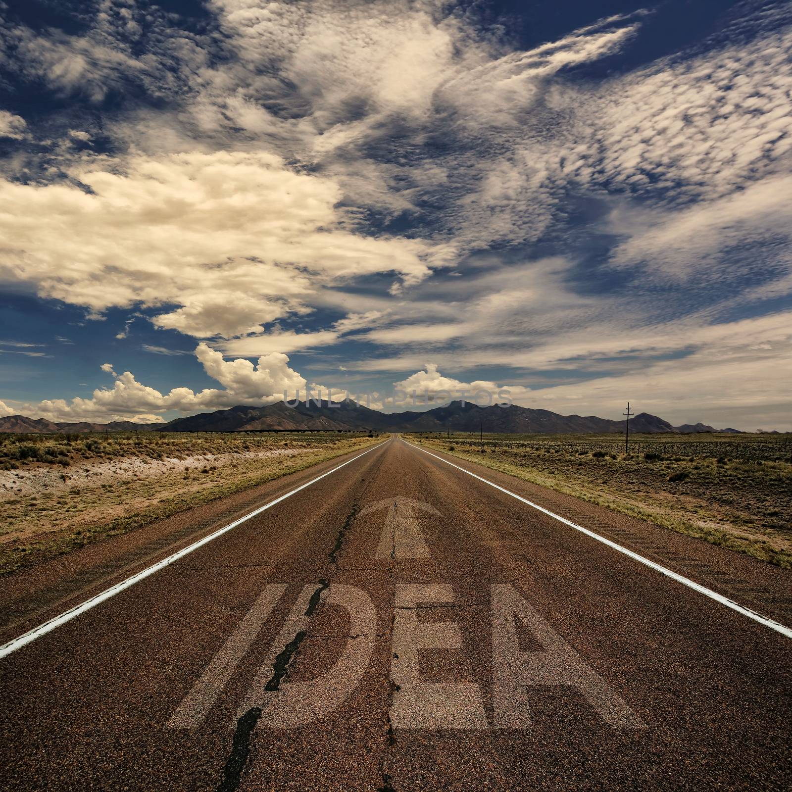 Conceptual image of desert road with the word idea and arrow
