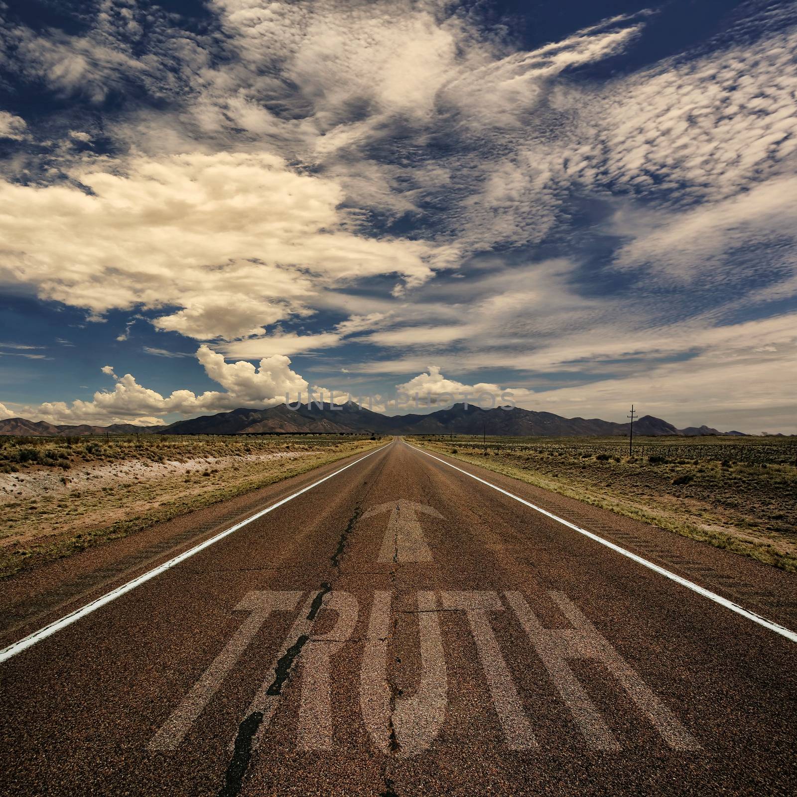 Conceptual image of desert road with the word truth and arrow