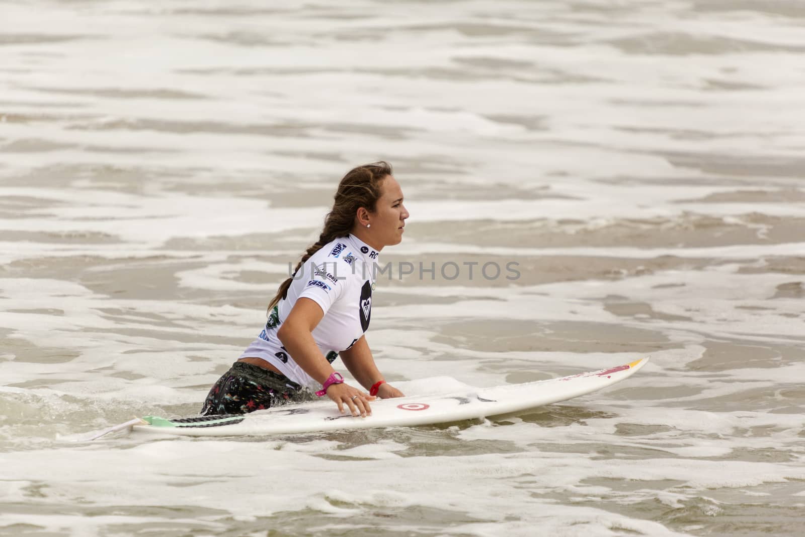 Unidentified Surfer walk into the water to races on the Quiksilver & Roxy Pro World Title Event. by Imagecom