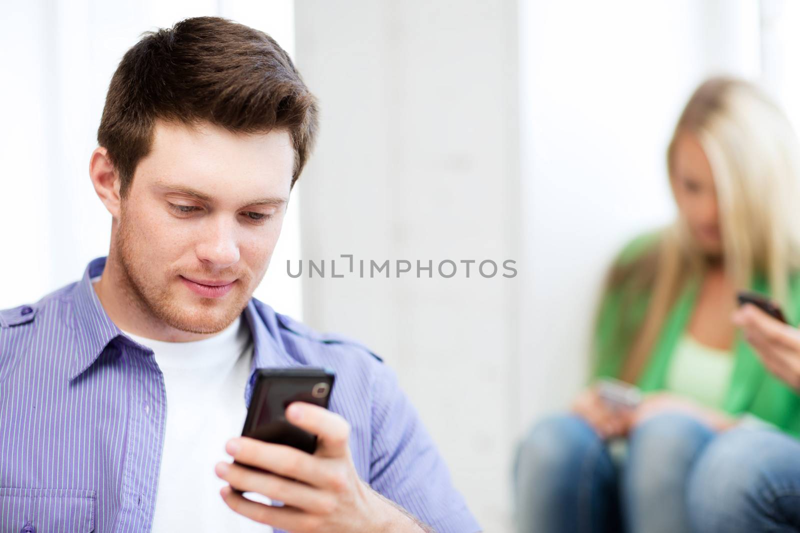 student looking at phone and tiping by dolgachov