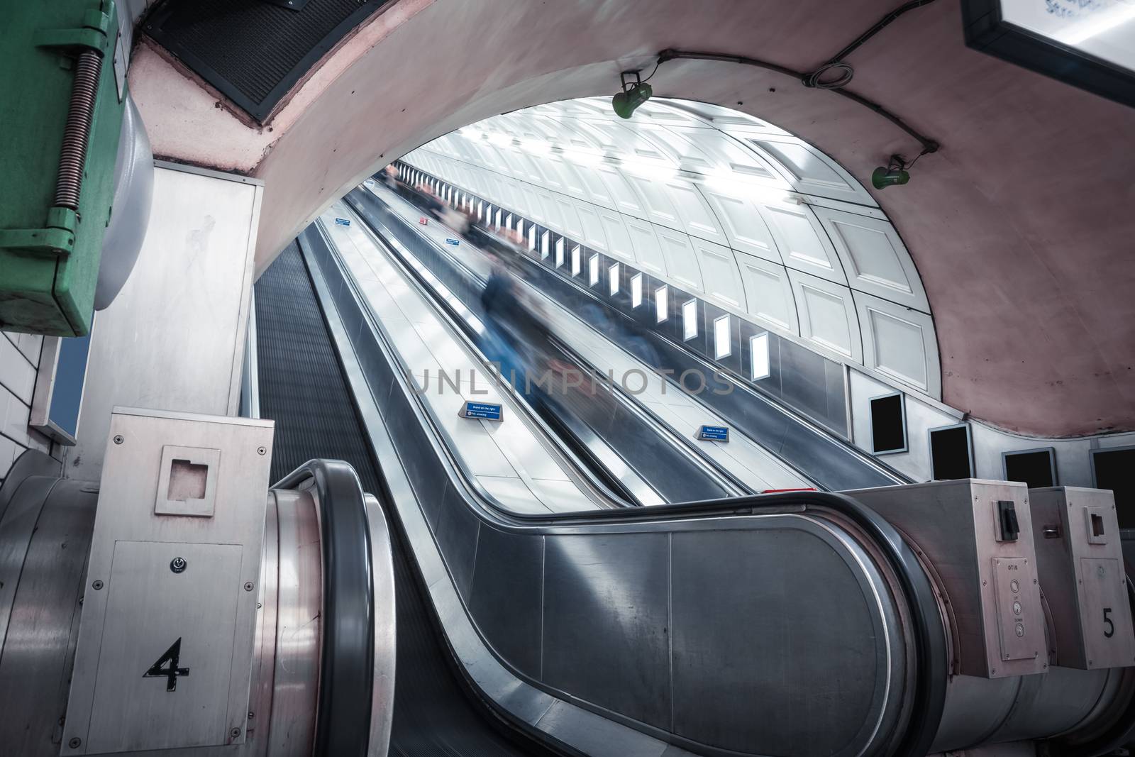 Escalator in one of Londons underground stations in thge city center. All adverts have been whitened out. No property release availabe, only for editorial use