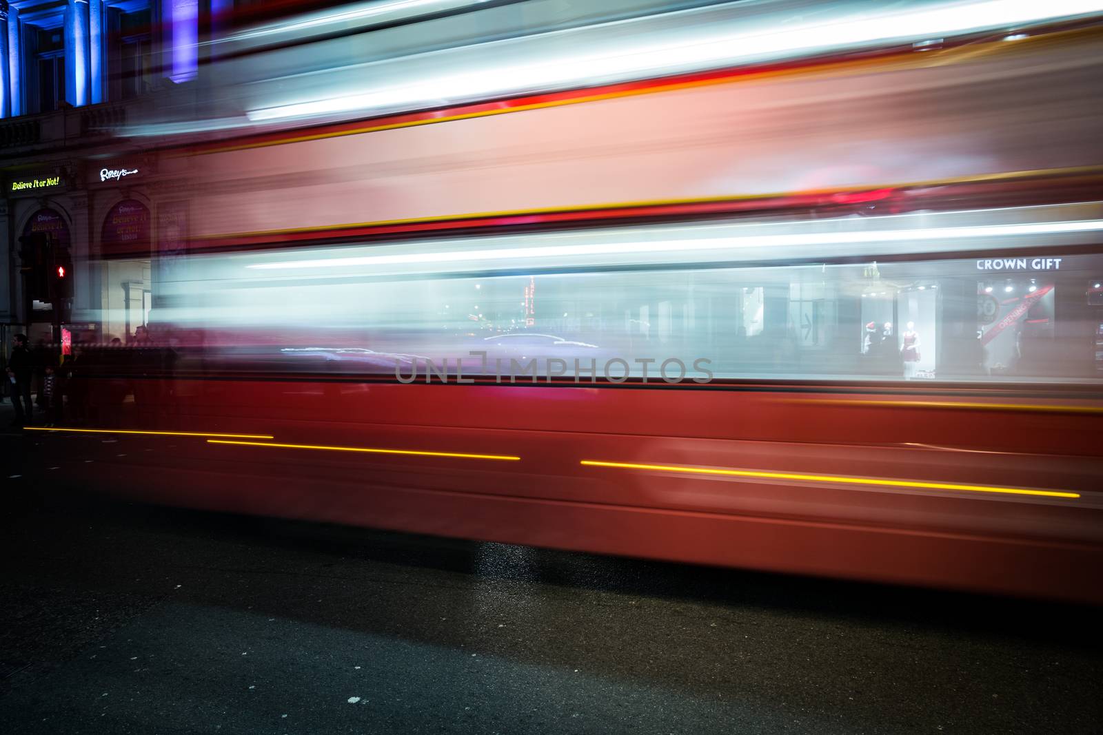 London's traffic at night with blurres and light streams of public transport near piccadilly circus.