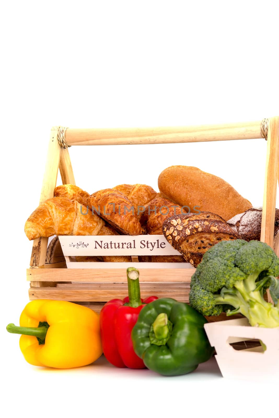 Composition with bread and vegetable in basket isolated on white .