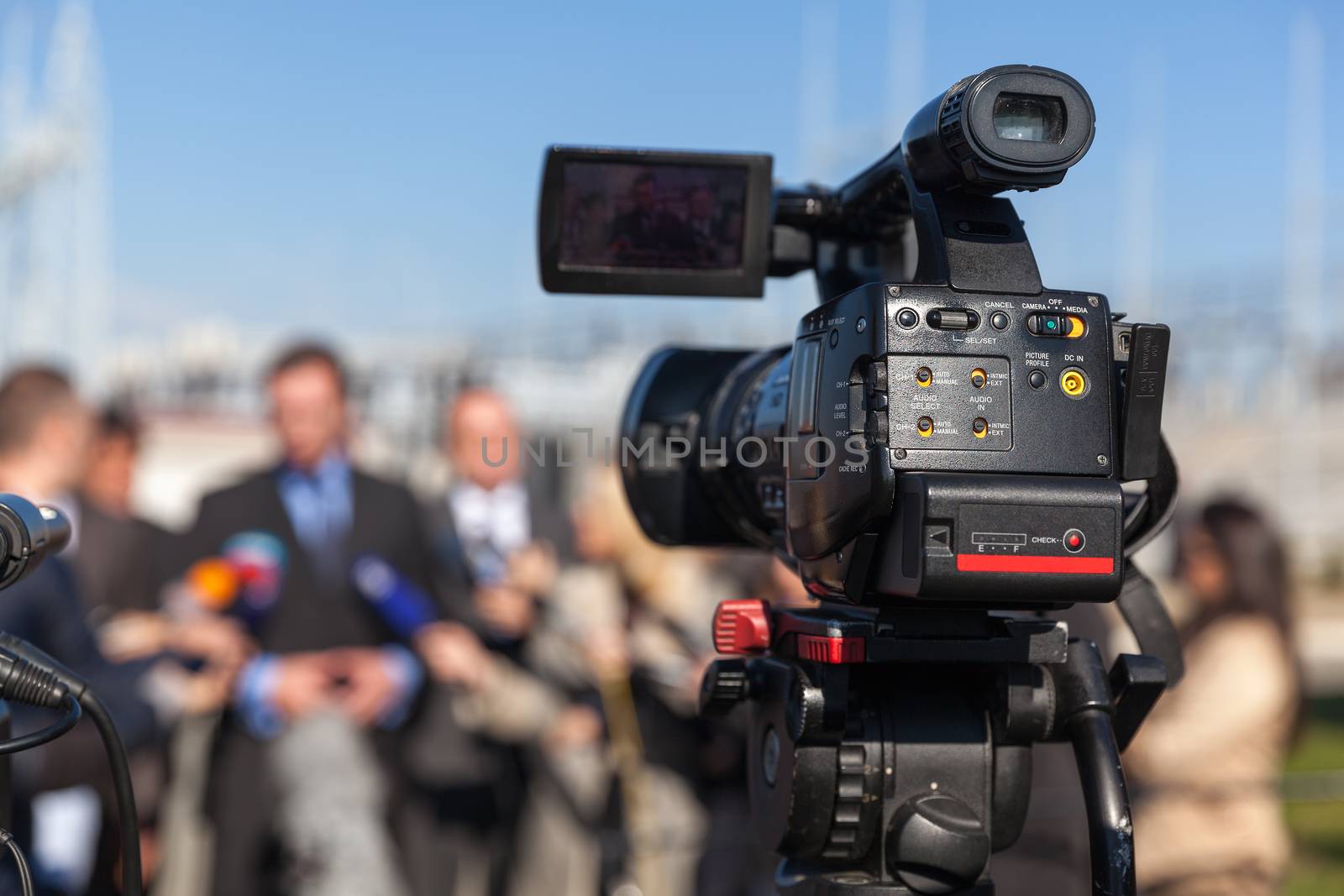 News conference. Filming an event with a video camera. by wellphoto