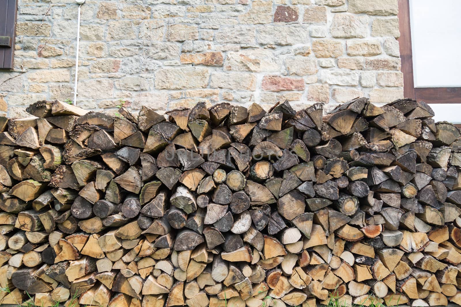 chopped wood in garden stacked to be used for fire place