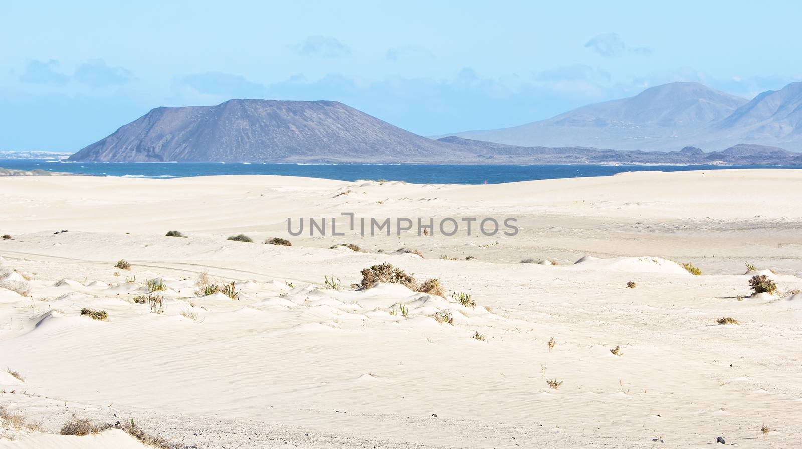 View of the volcano La Caldera on the small island of Los Lobos as seen from the dunes of Corralejo in the north east of Fuerteventura.